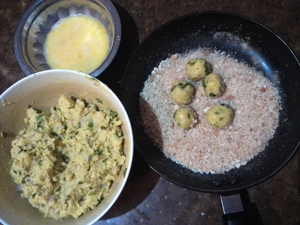 Potato cheese balls coated in beaten egg and breadcrumbs