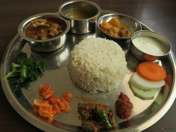 Thakali Khana set- Rice, Mustang beans daal, Mutton curry, Seasonal vegetable curry, Stir-fried spinach, Grated Radish pickle, Timur-Tomato chutney, Bitter guard pickle and Yoghurt
